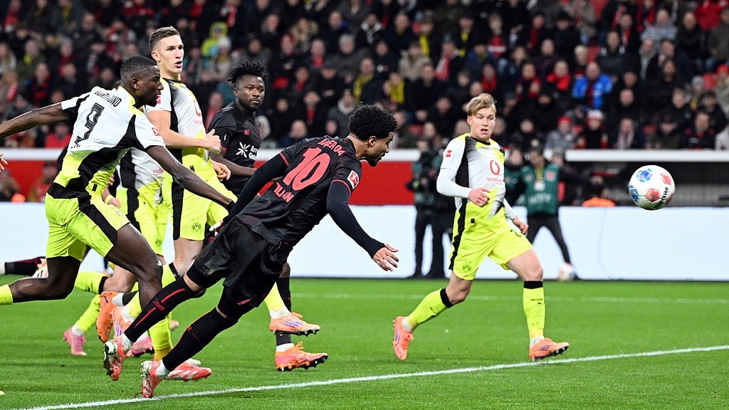 Photo: Federico Gambarini/dpa via AP : Bayer Leverkusen Vs Borussia Dortmund Highlights, Bundesliga: Malik Tillman, centre, and Serhou Guirassy fight for the ball.