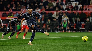 | Photo: AP/Joan Monfort : Real Madrid's Kylian Mbappe scores a penalty kick during a Spanish La Liga match against Girona on November 30, 2025.