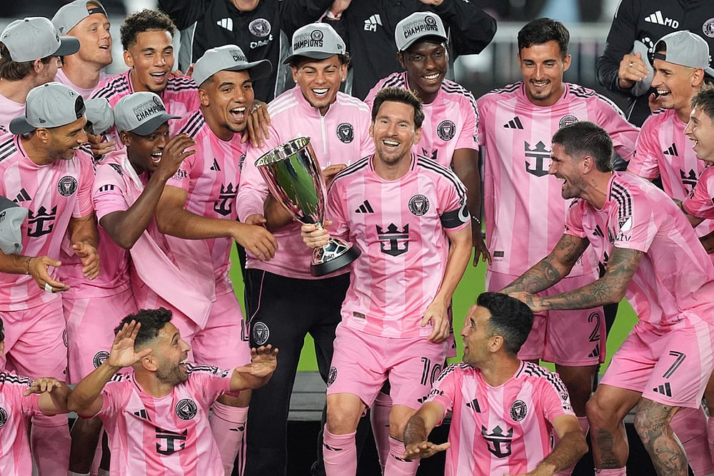 | Photo: AP/Rebecca Blackwell : Inter Miami forward Lionel Messi (10) holds the trophy as Inter Miami players celebrate winning an MLS Eastern Conference final soccer match against New York City FC, in Fort Lauderdale, Florida. 