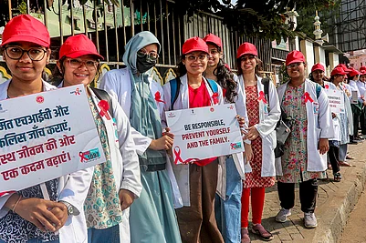 | Photo: PTI : Students form a human chain during an awareness rally on World AIDS Day, in Bhopal.