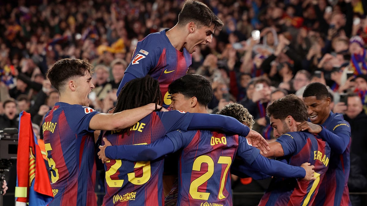 Barcelona's Ferran Torres celebrates with his teammates after scoring his side's third goal during the La Liga match against Atletico Madrid on December 2, 2025.