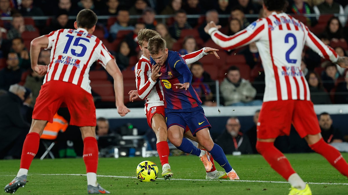 | Photo: AP/Joan Monfort : Atletico Madrid's Pablo Barrios fights for the ball against Barcelona's Dani Olmo during their Spanish La Liga match on December 2, 2025.