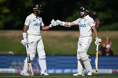 | Photo: Andrew Cornaga/Photosport via AP : New Zealands batters Rachin Ravindra, left, and Tom Latham encourage each other while batting against the West Indies on day 3 during their cricket test match in Christchurch, New Zealand.