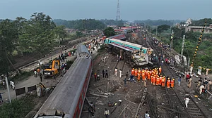 (AP Photo/Arabinda Mahapatra) : A drone shot of rescuers work at the site of passenger trains accident, in Balasore district, in the eastern Indian state of Orissa, Saturday, June 3, 2023. Rescuers are wading through piles of debris and wreckage to pull out bodies and free people after two passenger trains derailed in India, killing more than 280 people. Hundreds of others were trapped inside more than a dozen mangled rail cars, in one of the countrys deadliest train crashes in decades.