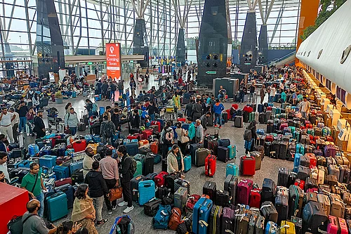 PTI/Shailendra Bhojak : Stranded passengers search for their luggage near a counter after IndiGo cancelled more than 400 flights, at the Kempegowda International Airport, in Bengaluru, Karnataka.