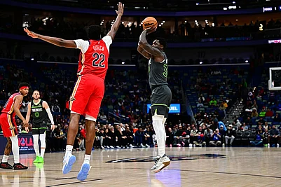 | Photo: AP/Ella Hall : Minnesota Timberwolves forward/center Julius Randle, right, goes up to shoot against New Orleans Pelicans center Derik Queen (22) in the first half of an NBA basketball game in New Orleans.