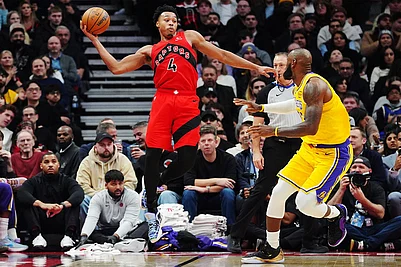 | Frank Gunn/The Canadian Press via AP : Toronto Raptors Scottie Barnes (4) looks to pass the ball over Los Angeles Lakers LeBron James, right, during second-half NBA basketball game action in Toronto.