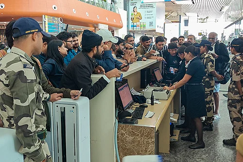Photo: PTI/Shailendra Bhojak : Passengers enquire about their IndiGo flight at a boarding gate at Kempegowda International Airport amid flight disruptions, in Bengaluru. IndiGos operations crumbled as pilot-rostering issues continued to force large scale flight cancellations -- over 400 on Friday -- and many passengers have been stranded for as long as three days at airports.