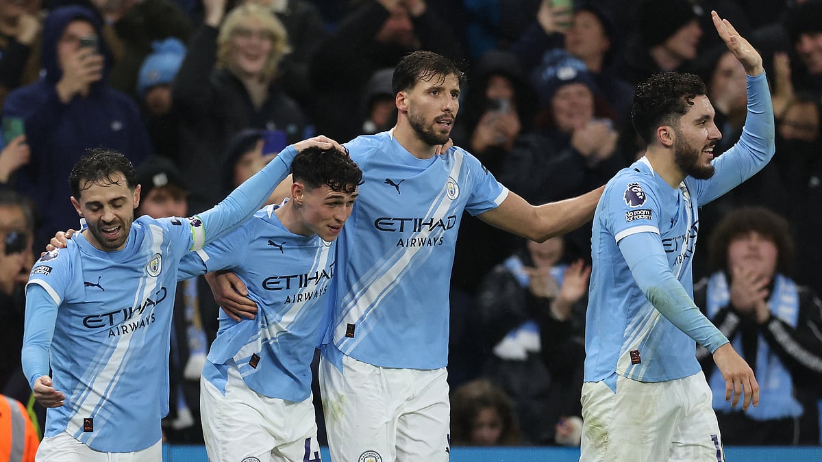 Manchester City players Bernardo Silva, Phil Foden, Ruben Dias and Rayan Cherki celebrate