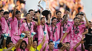 | Photo: The Canadian Press/Darryl Dyck via AP : Inter Miami's Lionel Messi hoists the trophy alongside teammates after defeating the Vancouver Whitecaps in the MLS Cup final match on December 6, 2025.