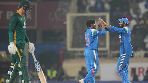 | Photo: AP/Rafiq Maqbool : Indias Kuldeep Yadav, centre, celebrates the wicket of South Africas Prenelan Subrayen during the first One Day International match between India and South Africa in Ranchi.