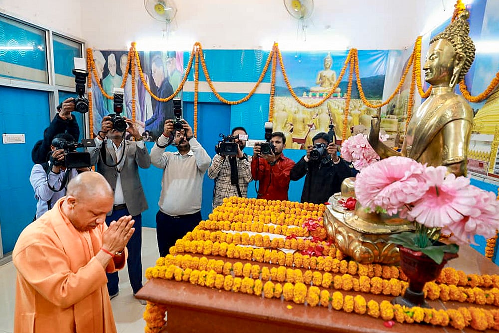 | Photo: Handout via PTI  : Uttar Pradesh Chief Minister Yogi Adityanath pays tribute to Lord Buddha during the 69th death anniversary of Babasaheb Ambedkar, also called ‘Mahaparinirvan Diwas’, at Bhimrao Ambedkar Mahasabha Office Complex, Hazratganj, in Lucknow. 