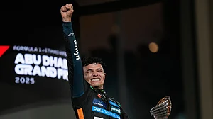 (AP Photo/Darko Bandic) : McLaren driver Lando Norris of Britain reacts after becoming a world champion after the Abu Dhabi Formula One Grand Prix in Abu Dhabi, United Arab Emirates, Sunday, Dec. 7, 2025.