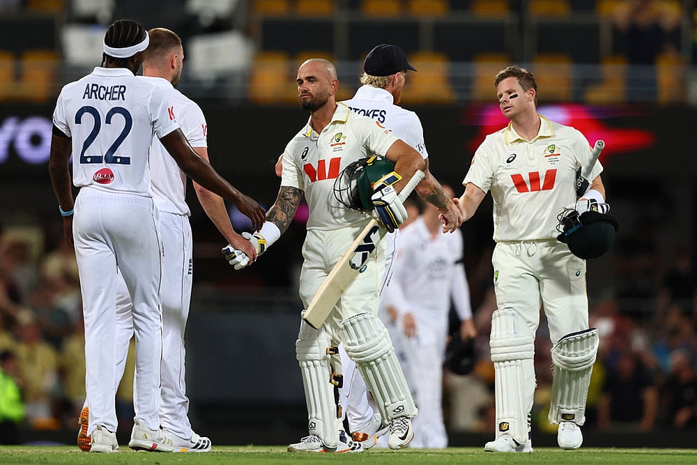 | Photo: AP/Tertius Pickard : Australias Jake Weatherald, front, and Australias captain Steve Smith shake hands with Englands players after winning the second Ashes cricket test match between Australia and England in Brisbane.