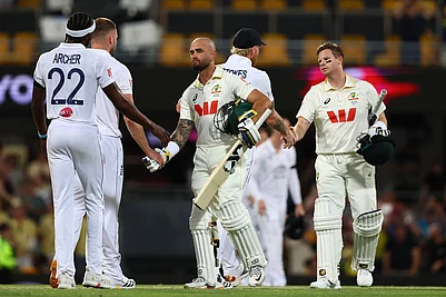 | Photo: AP/Tertius Pickard : Australias Jake Weatherald, front, and Australias captain Steve Smith shake hands with Englands players after winning the second Ashes cricket test match between Australia and England in Brisbane.
