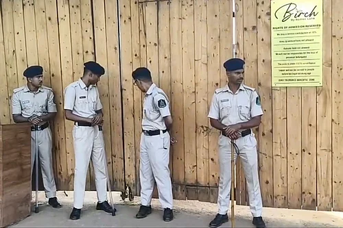 Photo: PTI : Police personnel keep vigil at the site after a fire broke out at a nightclub due to a cylinder blast, in North Goa. At least 23 people were killed in the incident, according to officials.