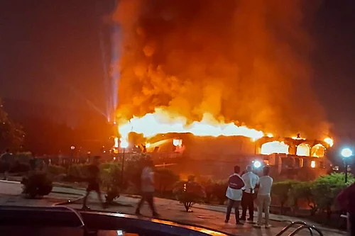 | Photo: PTI : Smoke and flames billow after a fire broke out due to a cylinder blast at a nightclub, in North Goa. At least 23 people were killed in the incident, according to officials.