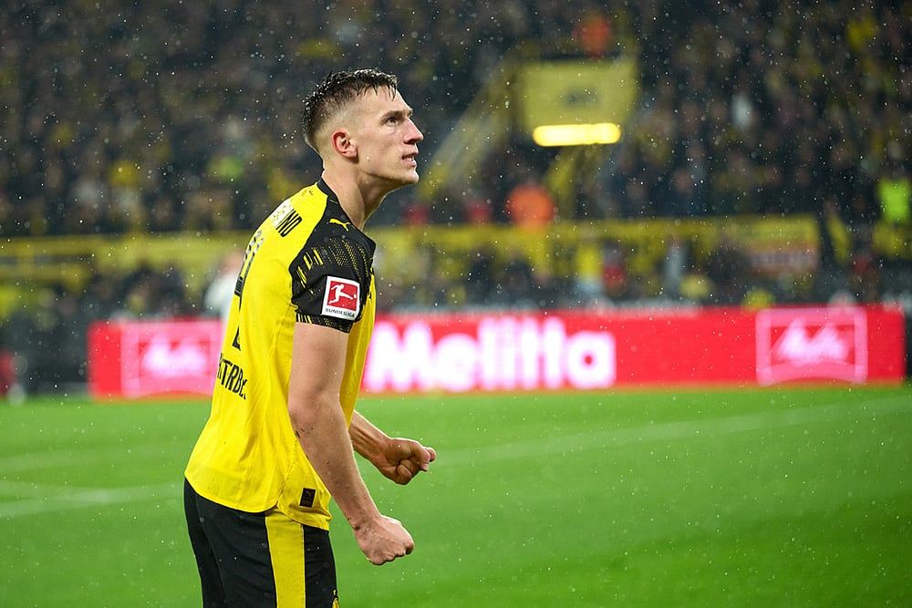 | Photo: Bernd Thissen/dpa via AP : Borussia's Nico Schlotterbeck celebrates after scoring his side's second goal during Germany Bundesliga soccer match between Borussia Dortmund and TSG 1899 Hoffenheim, in Dortmund, Germany.