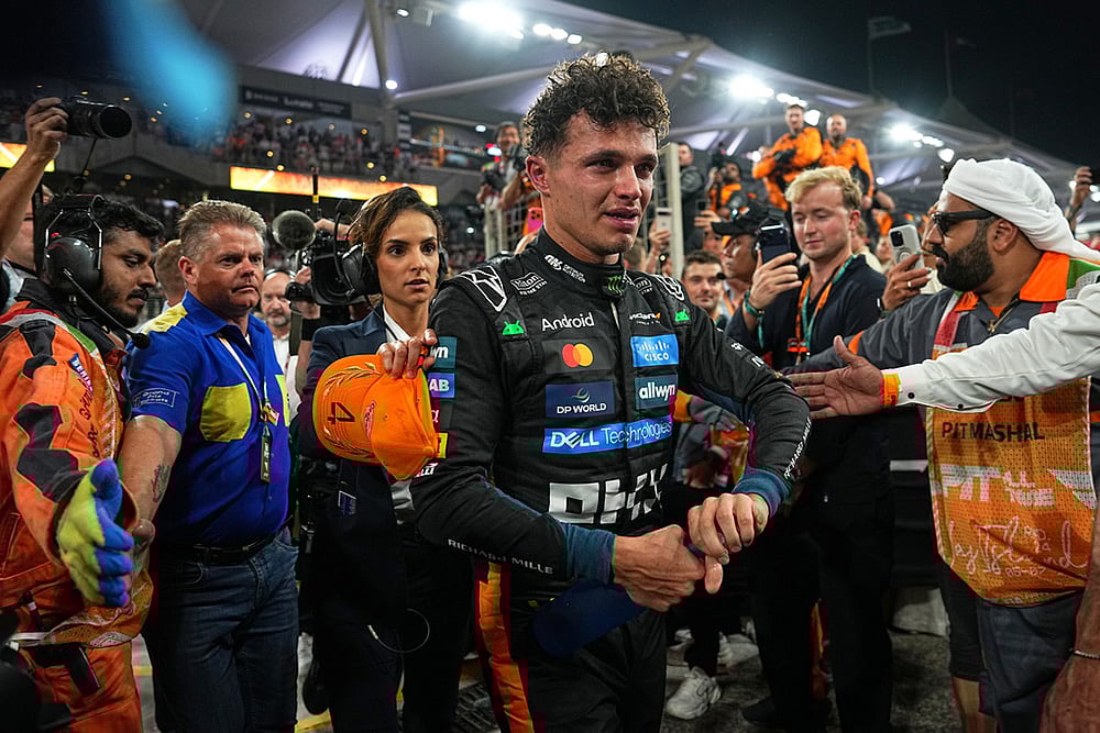 | Photo: AP/Fatima Shbair : New Formula One World Champion McLaren driver Lando Norris of Britain leaves the track after the Formula One Abu Dhabi Grand Prix at the Yas Marina Circuit in Abu Dhabi, UAE.