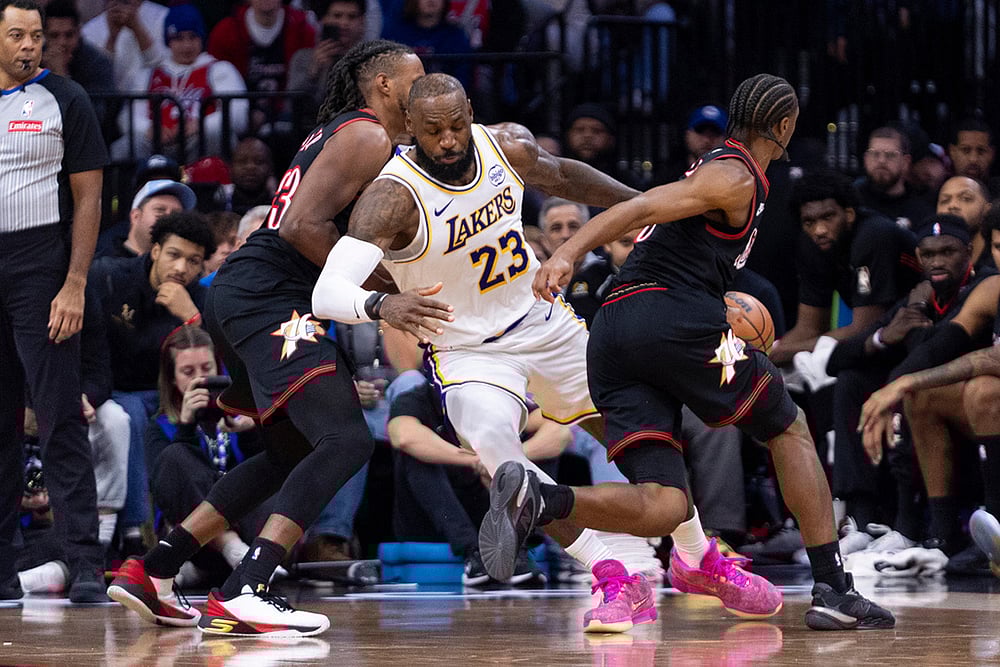 | Photo: AP/Chris Szagola : Los Angeles Lakers LeBron James, center, gets the ball stolen by Philadelphia 76ers Tyrese Maxey, right, as Jabari Walker, left, is defending during the second half of an NBA basketball game in Philadelphia.
