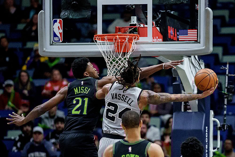 | Photo: AP/Matthew Hinton : New Orleans Pelicans center Yves Missi (21) fouls San Antonio Spurs guard/forward Devin Vassell (24) during the first half of an NBA basketball game in New Orleans.
