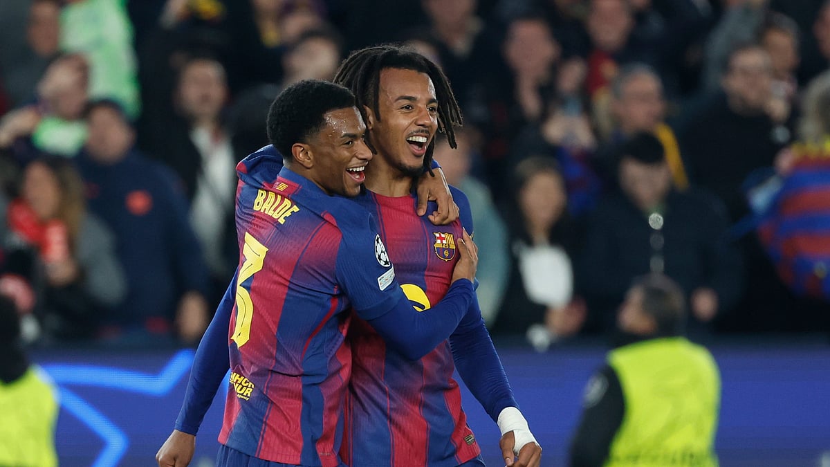 (AP Photo/Joan Monfort) : Barcelona's Jules Kounde right, celebrates with Alejandro Balde after scoring his side's second goal during the Champions League opening phase soccer match between Barcelona and Eintracht Frankfurt in Barcelona, Spain, Tuesday, Dec. 9, 2025.