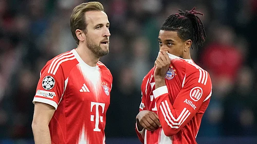 | Photo: AP/Matthias Schrader : Bayern Munichs Michael Olise talks to Harry Kane during the UEFA Champions League opening phase match against Sporting CP on December 9, 2025.