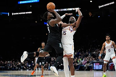 | Photo: AP/Abbie Parr : Minnesota Timberwolves guard Anthony Edwards (5) shoots over Phoenix Suns center Mark Williams (15) during the first half of an NBA basketball game in Minneapolis.