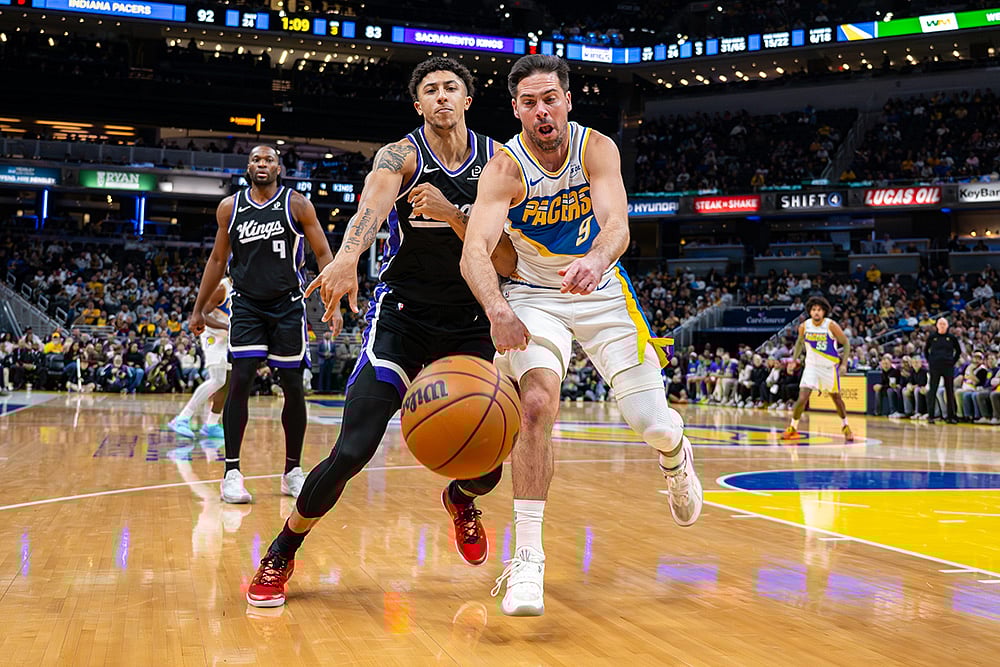 | Photo: AP/Doug McSchooler : Sacramento Kings guard Nique Clifford, left, and Indiana Pacers guard T.J. McConnell (9) battle for the ball during the second half of an NBA basketball game in Indianapolis.
