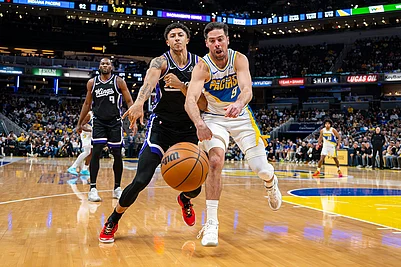 | Photo: AP/Doug McSchooler : Sacramento Kings guard Nique Clifford, left, and Indiana Pacers guard T.J. McConnell (9) battle for the ball during the second half of an NBA basketball game in Indianapolis.
