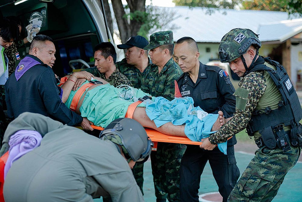| Photo: Royal Thai Army via AP : In this photo released by Royal Thai Army, a wounded Thai soldier is carried to be transferred to a hospital in Sisaket province, Thailand after, according to a Thai army spokesperson, Cambodian troops fired into Thai territory. 