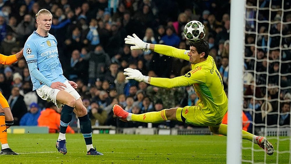 | Photo: AP/Dave Thompson : Champions League playoff first leg: Manchester City's Erling Haaland shoots to score past Real Madrid's goalkeeper Thibaut Courtois