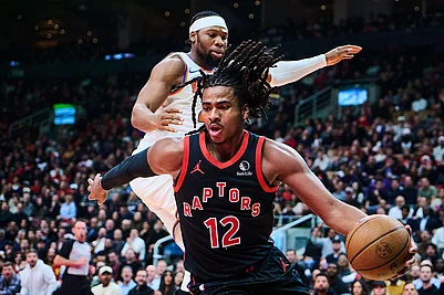 | Photo: Sammy Kogan/The Canadian Press via AP : Toronto Raptors Collin Murray-Boyles (12) drives past New York Knicks Guerschon Yabusele (28) during the first half of an NBA Cup basketball game in Toronto.