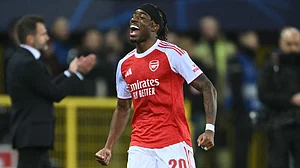 Arsenal's Noni Madueke celebrates scoring for his side during the UEFA Champions League match against Club Brugge.