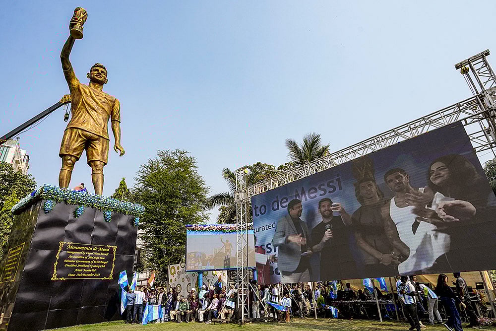 | Photo: PTI/Manvender Vashist Lav : Argentine footballer Lionel Messi with TMC MLA Sujit Bose virtually unveils his 70-feet statue as part of his G.O.A.T. India Tour 2025, in Kolkata.