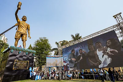 | Photo: PTI/Manvender Vashist Lav : Argentine footballer Lionel Messi with TMC MLA Sujit Bose virtually unveils his 70-feet statue as part of his G.O.A.T. India Tour 2025, in Kolkata.