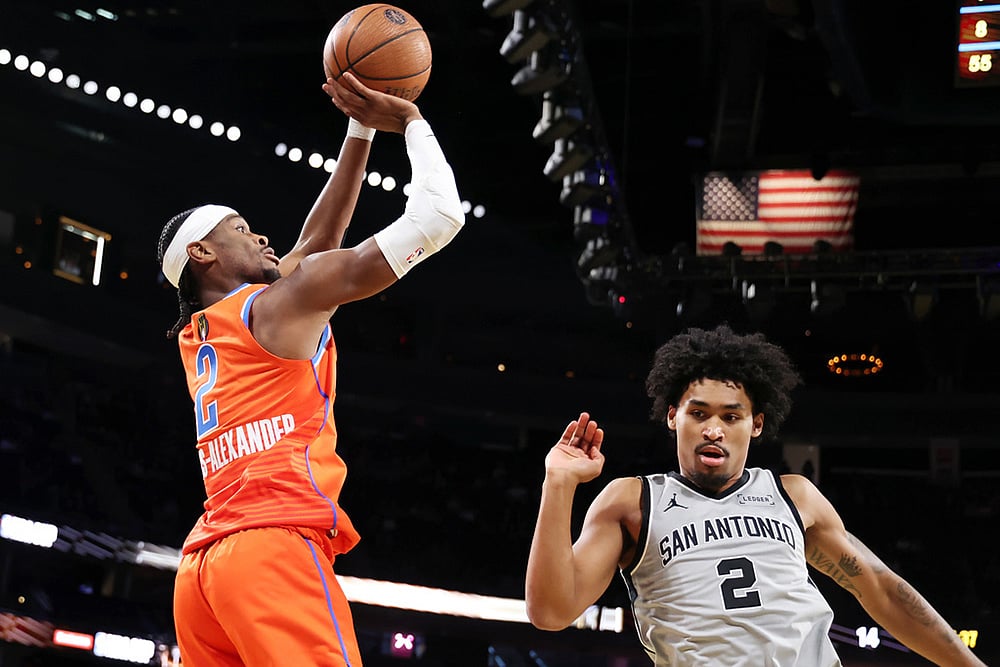 | Photo: AP/Ronda Churchill : Oklahoma City Thunder guard Shai Gilgeous-Alexander (2) goes for a shot over San Antonio Spurs guard Dylan Harper (2) in the first half of an NBA Cup semifinals basketball game in Las Vegas.