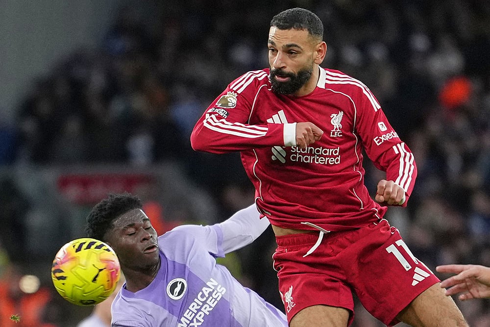 | Photo: AP/Jon Super : Liverpools Mohamed Salah, right, challenges for the ball with Brightons Carlos Baleba, left, during the English Premier League soccer match between Liverpool and Brighton and Hove Albion in Liverpool, England.