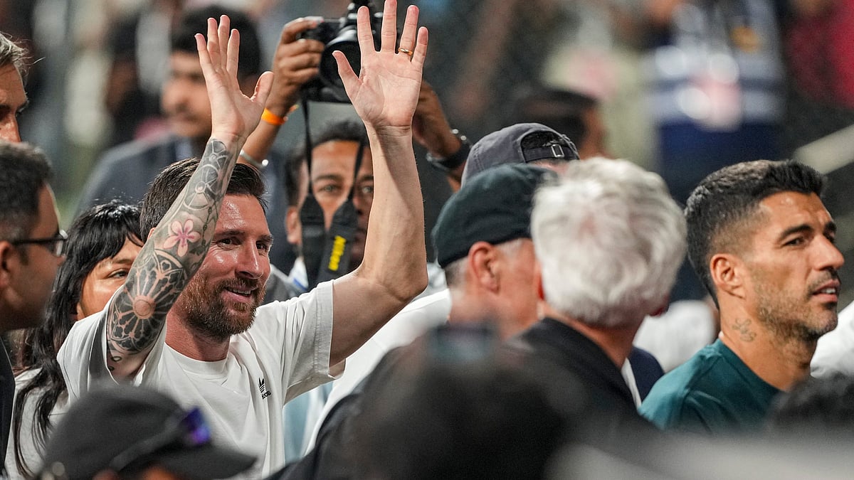 | Photo: PTI/Kunal Patil : Argentine footballer and 2022 FIFA World Cup winning captain Lionel Messi, left, greets fans during an event as part of the 'GOAT India Tour 2025', at the Wankhede Stadium, in Mumbai, Sunday, Dec. 14, 2025. Inter Miami player Luis Suarez, right, is also seen. 
