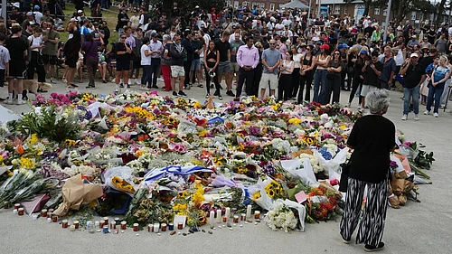 AP : People gather at a growing flower memorial to shooting victims outside the Bondi Pavilion at Sydneys Bondi Beach.