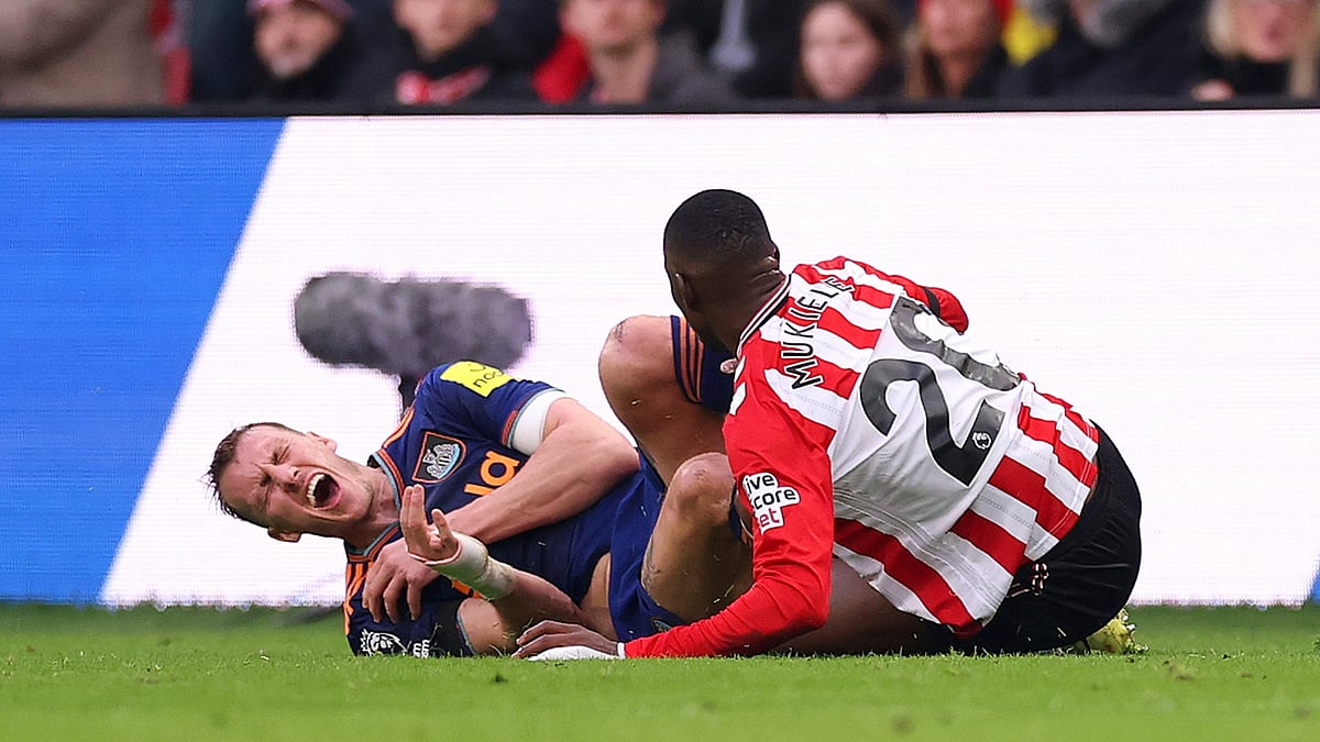 Newcastle defender Dan Burn is injured in a tackle with Nordi Mukiele