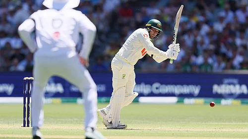 | Photo: AP/James Elsby : Australias Usman Khawaja plays a shot during play on day one of the third Ashes Test on December 17, 2025.