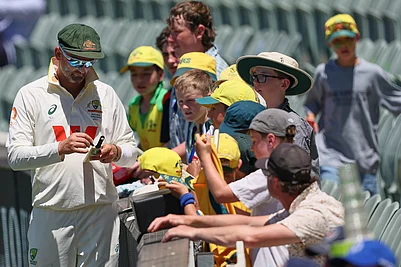 | Photo: AP/James Elsby : Australias Nathan Lyon signs autograph to fans during play on day two of the third Ashes cricket test between England and Australia in Adelaide, Australia.