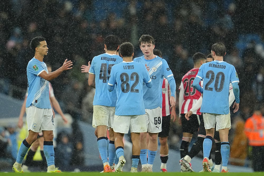 | Photo: AP/Jon Super : Manchester City's Rico Lewis shakes hands with Manchester City's Charlie Gray after the English League Cup soccer match between Manchester City and Brentford in Manchester, England.