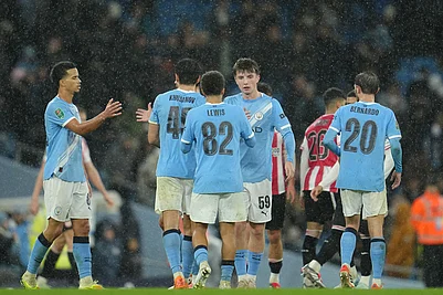 | Photo: AP/Jon Super : Manchester Citys Rico Lewis shakes hands with Manchester Citys Charlie Gray after the English League Cup soccer match between Manchester City and Brentford in Manchester, England.