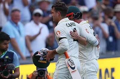 | Photo: AP/James Elsby : Australias not out batsmen Alex Carey, left, and Travis Head leave the field at the end of play on day three of the third Ashes cricket test between England and Australia in Adelaide, Australia.