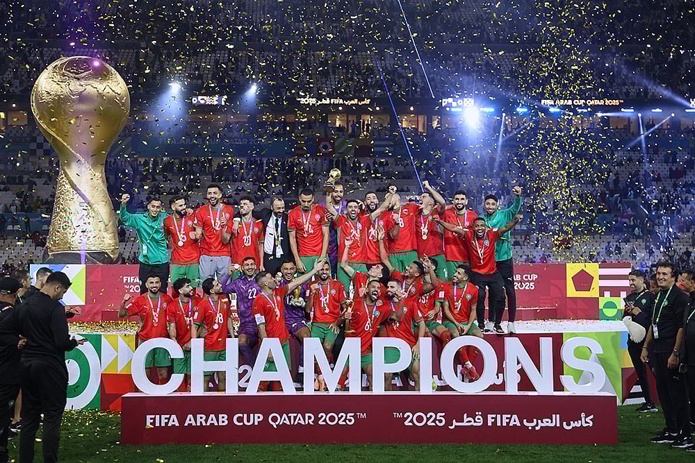 | Photo: AP/Hussein Sayed : Morocco's players celebrate with the winner trophy after defeating Jordan in the FIFA Arab Cup final soccer match in Lusail, Qatar. 