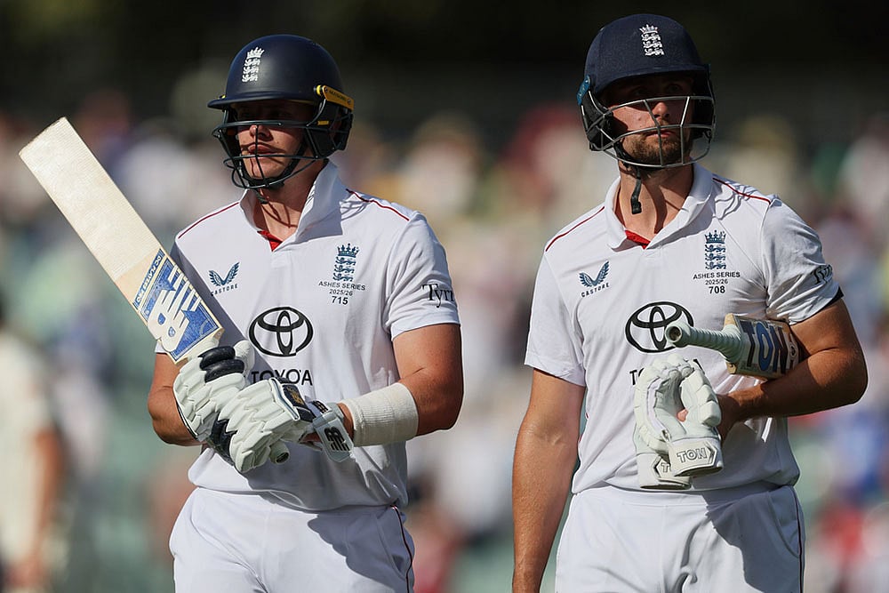 | Photo: AP/James Elsby : Englands Jamie Smith, left, and Will Jacks walk from the field after play ended on day four of the third Ashes cricket test between England and Australia in Adelaide, Australia.