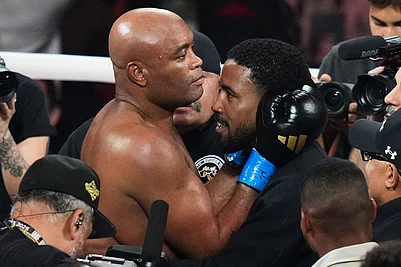 | Photo: AP/Lynne Sladky : Anderson Silva, center left, is embraced after his knockdown of Tyron Woodley during their cruiserweight fight in Miami.