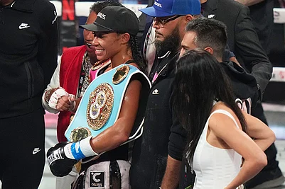 | Photo: AP/Lynne Sladky : Alycia Baumgardner, left, poses with her belt after her during super-featherweight fight against Lela Beaudoin in Miami.